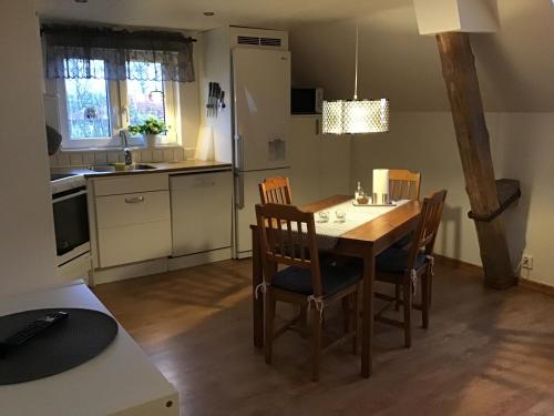 a kitchen and dining room with a table and chairs at Nordanå Gård in Strö