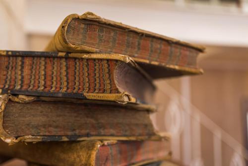 three old books stacked on top of each other at Valletta Lucente Guest House in Valletta