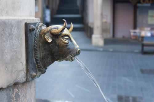 a statue of a cow drinking water from a fountain at Hotel Torico Plaza in Teruel