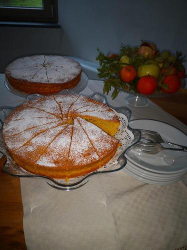 a table with two cakes on a table at Regia Hotel in Abbasanta
