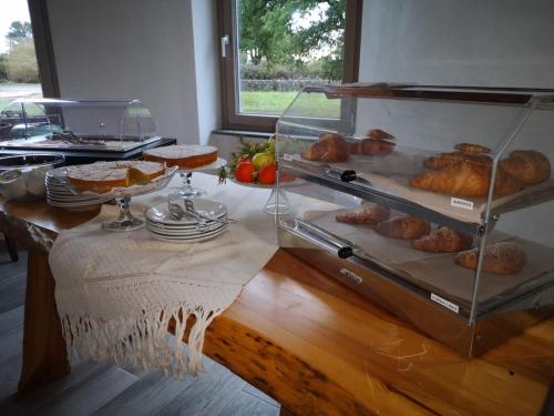 a display case with bread and pastries on a table at Regia Hotel in Abbasanta