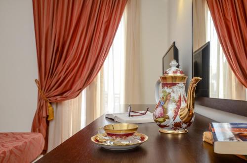 a living room with a table with a vase on it at Aeolis Boutique Hotel in Naxos Chora