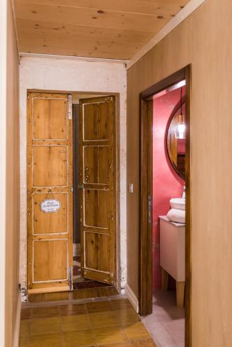 a hallway with a door and a mirror in a room at Valletta Lucente Guest House in Valletta