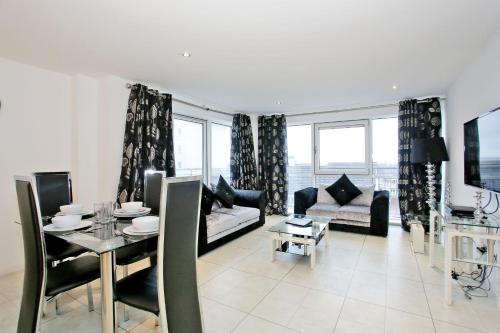 a living room with a couch and a table at Orange Apartments - Kepplestone in Aberdeen
