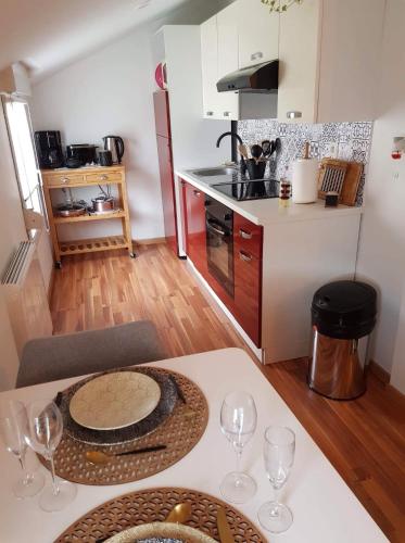 a kitchen with a table with wine glasses on it at Champétillant in Épernay