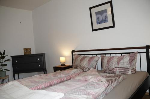 een bed in een slaapkamer met een foto aan de muur bij Ferienwohnung auf Resthof in Nordhorn