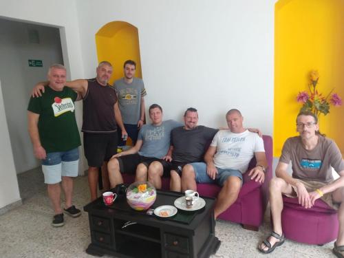 a group of men sitting in a living room at Casa de Luna in La Dorada
