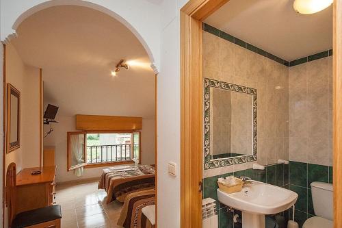 a bathroom with a sink and a mirror at Hostal Vinuesa in Vinuesa