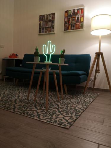 a living room with a couch and a table with cactus at Brutia Mom&Son in Cosenza