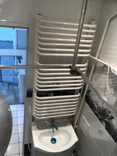 a bathroom with a toilet and a stack of plates at APARTAMENT W CENTRUM (STUDIO)!!! in Radom