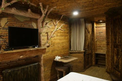 a room with a tv on a brick wall at Boutique Fantasy in Tbilisi City
