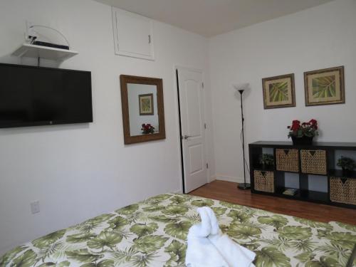 a bedroom with a bed and a flat screen tv at Harding Boutique Apartments in Miami Beach