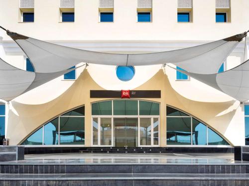 a building with a large white building at ibis Muscat in Muscat