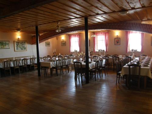 a large room with tables and chairs in it at Guesthouse Močivnik in Okroglice
