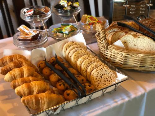 a buffet of bread and pastries on a table at New Inn by Greene King Inns in Newport