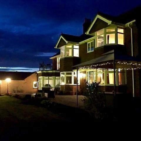 a large house at night with lights on it at The Moorhead Bed & Breakfast in Wem