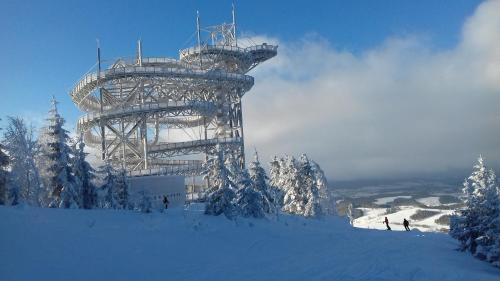a metal structure on top of a snow covered slope at Penzion Červená voda -penzion s dotekem dálek in Červená Voda