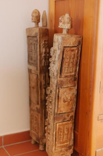 two ancient wooden crates sitting next to a wall at Penzion Červená voda -penzion s dotekem dálek in Červená Voda