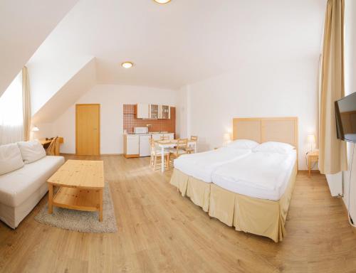 a large bedroom with a large bed and a table at Penzion Červená voda -penzion s dotekem dálek in Červená Voda