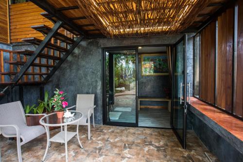 an open door to a patio with a table and chairs at Andalay Beach Resort Koh Libong in Ko Libong