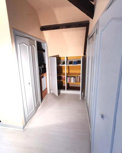 an empty hallway with an open door in a room at La demeure aux Pins in Lourdes