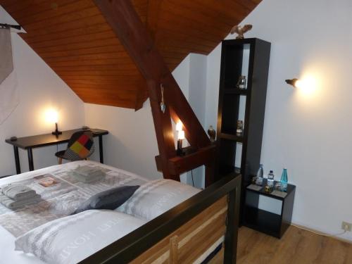 a bedroom with a bed and a wooden ceiling at LES CHAMBRES DU GAVE D'OSSAU in Arudy