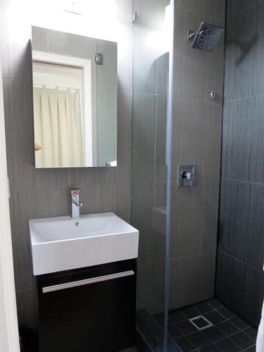 a bathroom with a white sink and a shower at Harding Boutique Apartments in Miami Beach