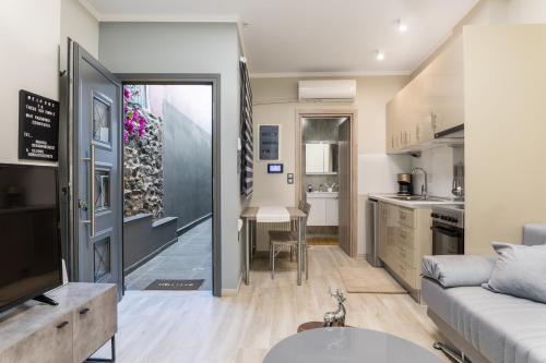 a living room with a couch and a kitchen at THESS OLD TOWN 2 free private parking of stayinthess in Thessaloniki