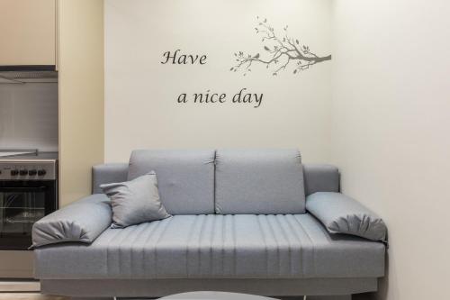 a couch with have a nice day sign on a wall at THESS OLD TOWN 2 free private parking of stayinthess in Thessaloniki