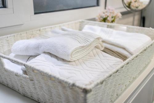 a basket with towels on a counter in a bathroom at Flatguest Luis Morote + Central + Beach + WiFi in Las Palmas de Gran Canaria