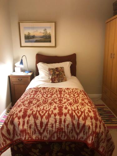 a bedroom with a bed with a pillow on it at Victoria Villas in London