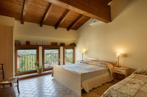 a bedroom with a large bed and a large window at Agriturismo Ca' del Ciuco in Vezzano sul Crostolo