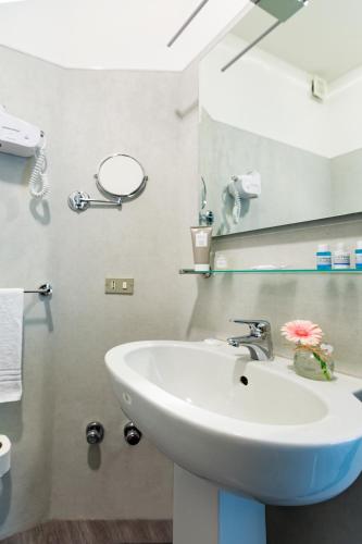 a bathroom with a sink and a mirror at Hotel Oleggio Malpensa in Oleggio