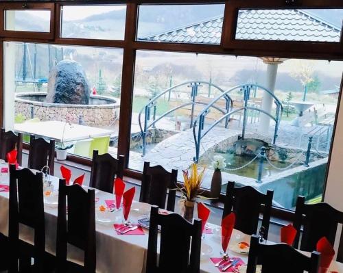 a dining room with a view of a playground at OMLADINSKI HOTEL ROSTOVO in Bugojno