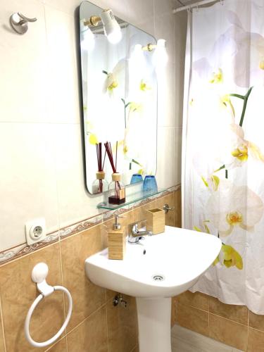 a bathroom with a sink and a mirror at Resitur Luxury Apartment 113 in Seville