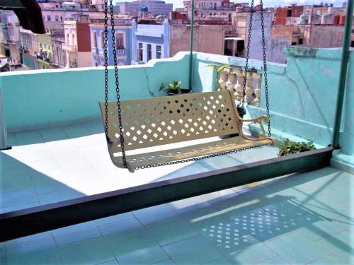 a swing on a balcony with a view of a city at Casa Colonial La Terraza in Havana