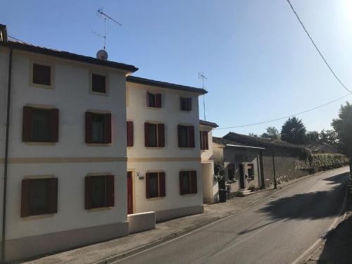 a white building on the side of a street at CASA San Gallo in Farra di Soligo