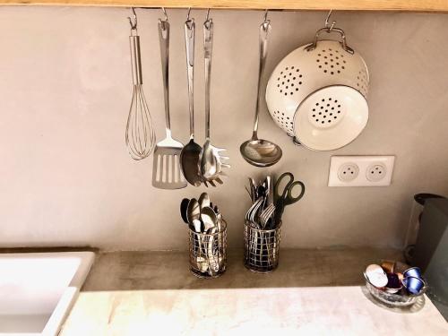 a kitchen counter with utensils and utensils at VILLA CAMPANA - Bastia centre in Bastia