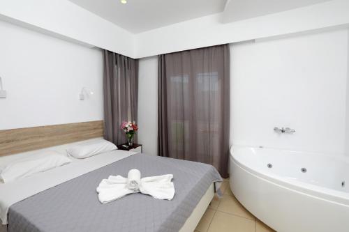 - une chambre avec un lit et une baignoire dans l'établissement Pension Verykokkos, à Naxos Chora