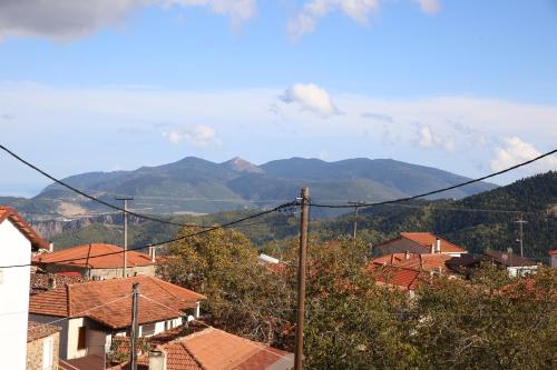 a view of a town with mountains in the background at Holiday Home in the Center of the Village in Pávliani