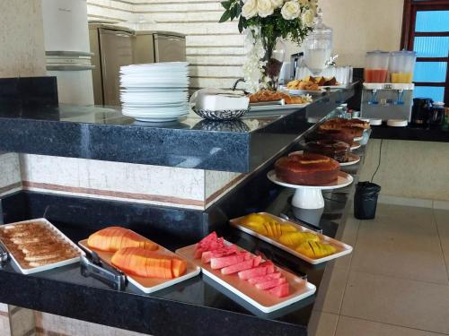 a buffet line with many different types of food at Pousada Vistazul - Pé na Areia in Bertioga