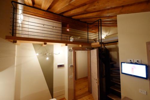 a room with a bunk bed and a flat screen tv at Chalet C'Est La Vie in Livigno