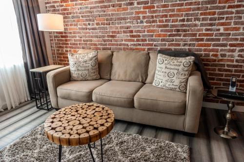 a living room with a couch and a brick wall at Artisan Downtown in DeLand