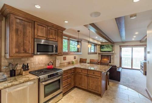 a kitchen with wooden cabinets and a stove top oven at Villa Cortina 130 in Vail Village in Vail