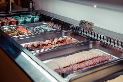 a display case with hot dogs and other foods at Grand Lakes 2 in Plitvička Jezera