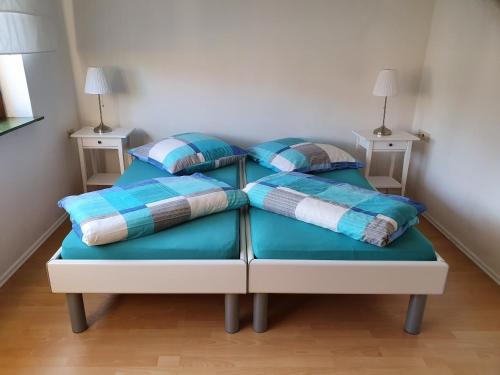 a bed with pillows on it in a room at Ferienwohnung Urlaub im Kraichgau in Sinsheim