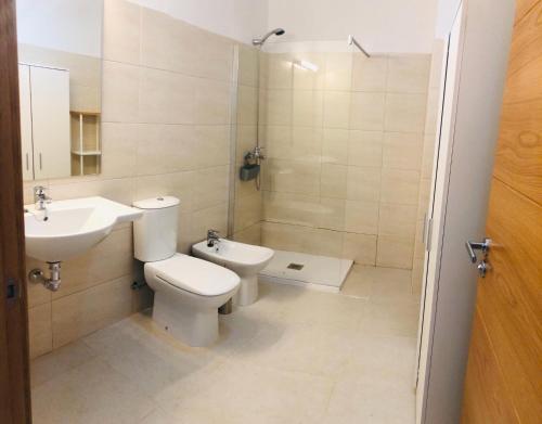 Un baño con inodoro, lavabo y ducha. en Suite ladybird, en Breña Baja