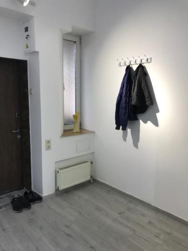 a room with a white wall with a coat rack at Apartment suite Mukachevo in Mukacheve