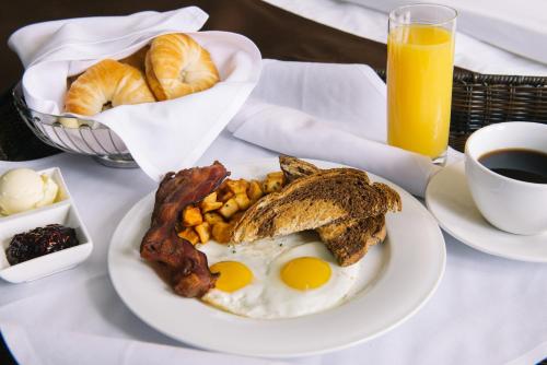 a breakfast plate with eggs bacon and toast and a cup of coffee at The Brunswick Hotel in Brunswick