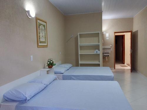 Ένα ή περισσότερα κρεβάτια σε δωμάτιο στο Sapê Suítes